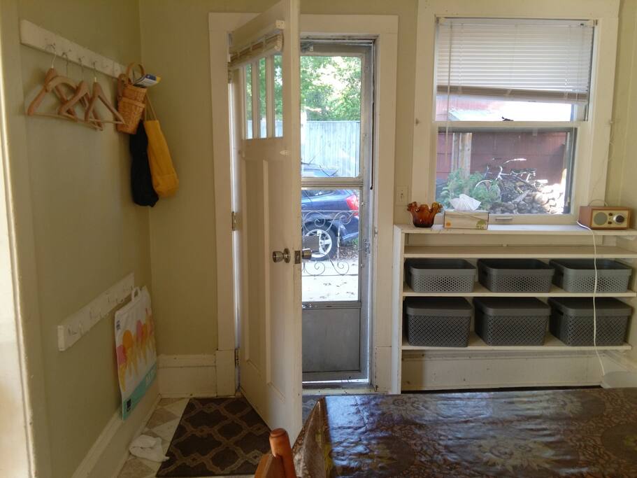 Front entry way includes open storage and coat hangers.