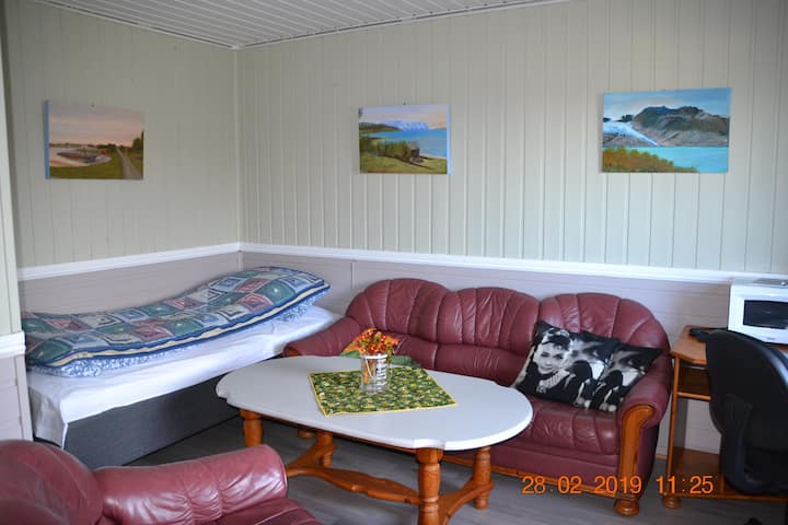 Časť obývacej izby s posteľou