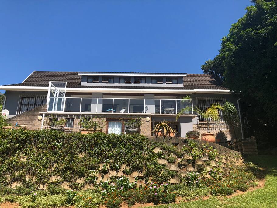 Exterior view of the house from the garden - spacious and compact at the same time. Pool deck in the foreground - great for braais and holiday relaxing.
