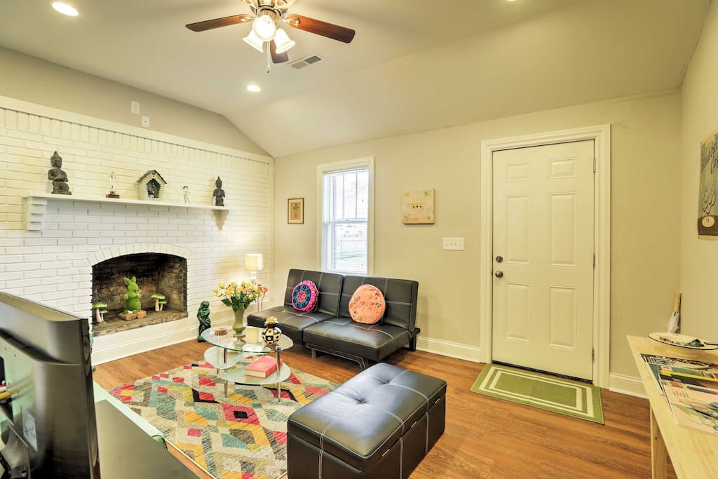 This beautiful living room features plush leather furniture, a decorative fireplace, and a flat-screen cable TV.