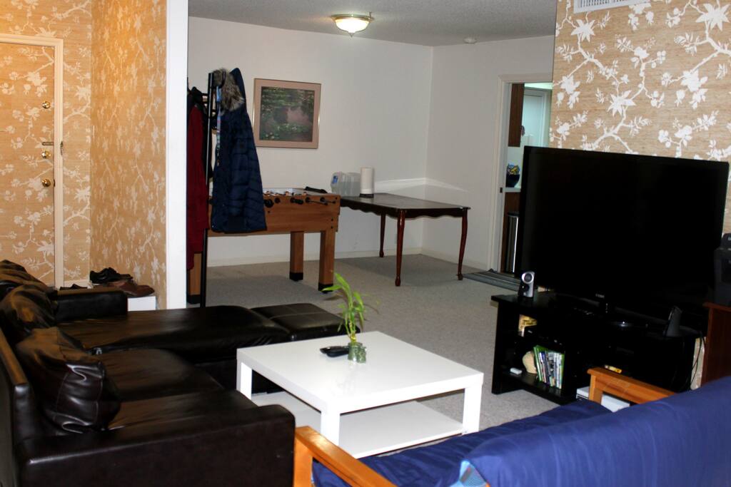 Living room with 55 inch TV and foosball table