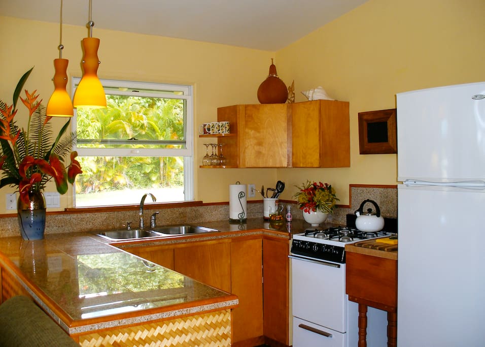 The kitchen is complete with pots/pans, dishware and cutlery. It has everything you need to prepare a nice meal in your hale (home) away from home