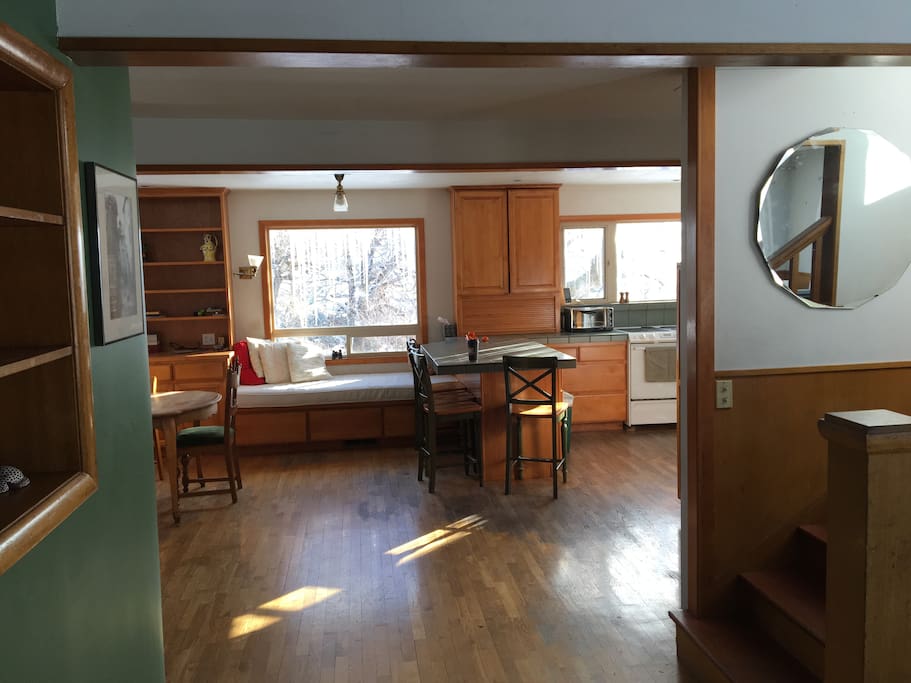 View from the front door, living room, stairs to attic bedrooms on right, kitchen, dining area straight ahead