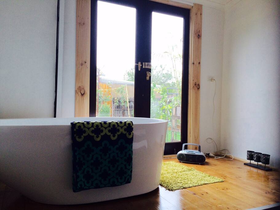 Winding down in a bubble bath with garden view