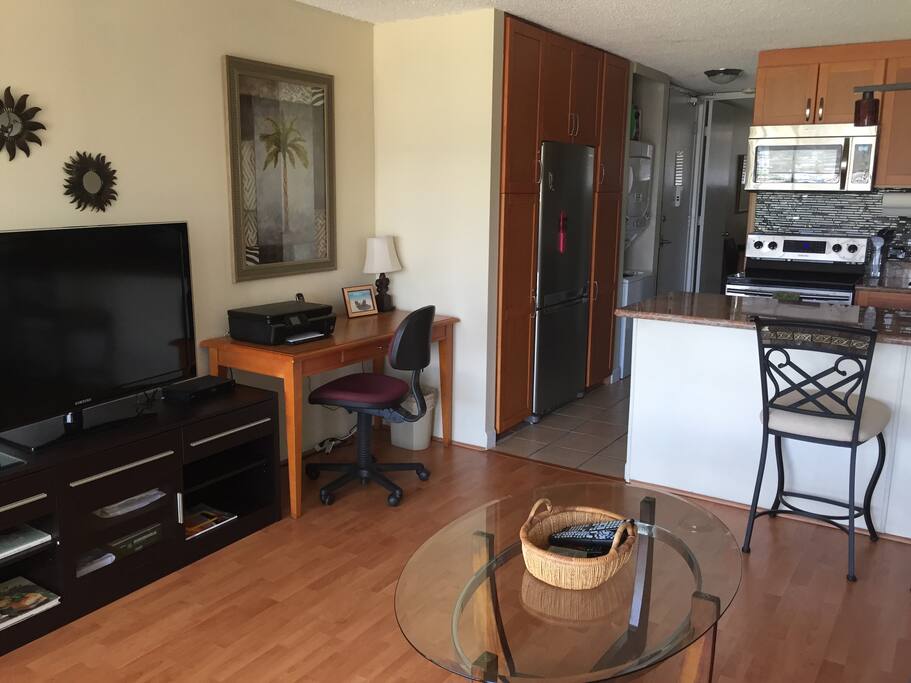 Big LCD TV with digital cable and music channel. Work desk and printer.