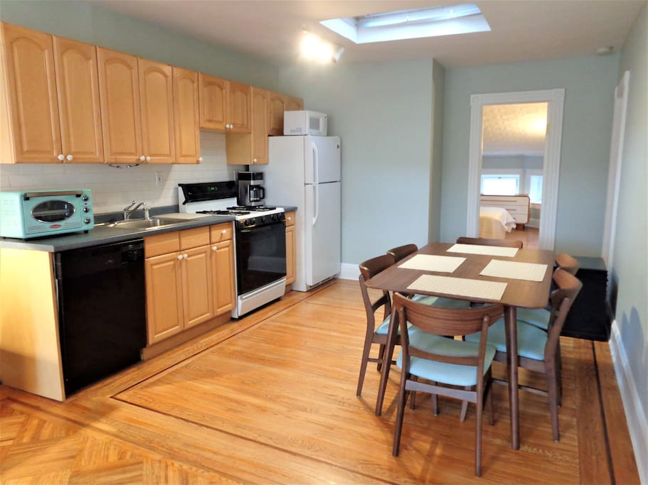 The kitchen has a dishwasher and is fully stocked with all the necessary amenities. The dining area has plenty of seating.