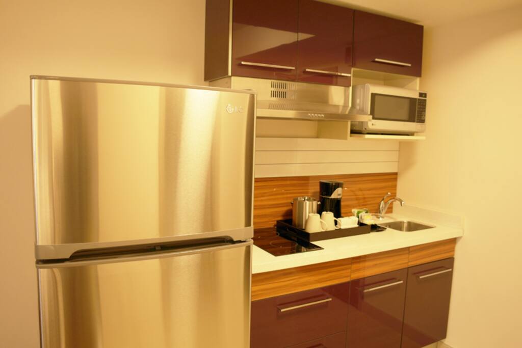 This is the kitchenette you will find in your room. Full size fridge, 2 burner induction hot plate, microwave, and coffee pot. All dishes are also supplied.
