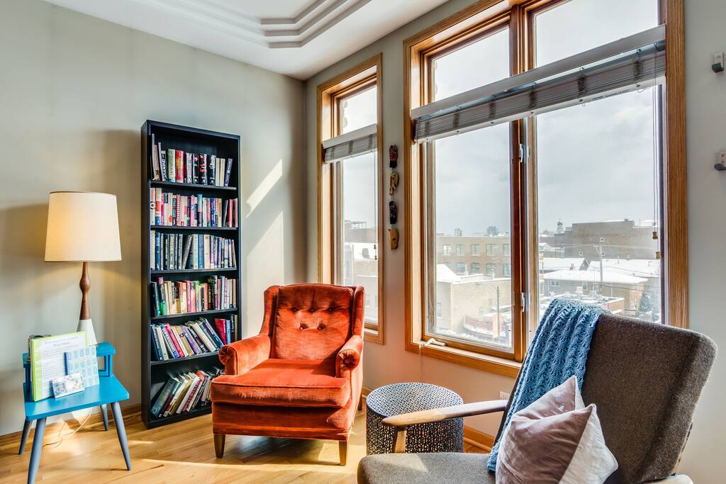You'll be able to see all of downtown from this cozy orange chair!