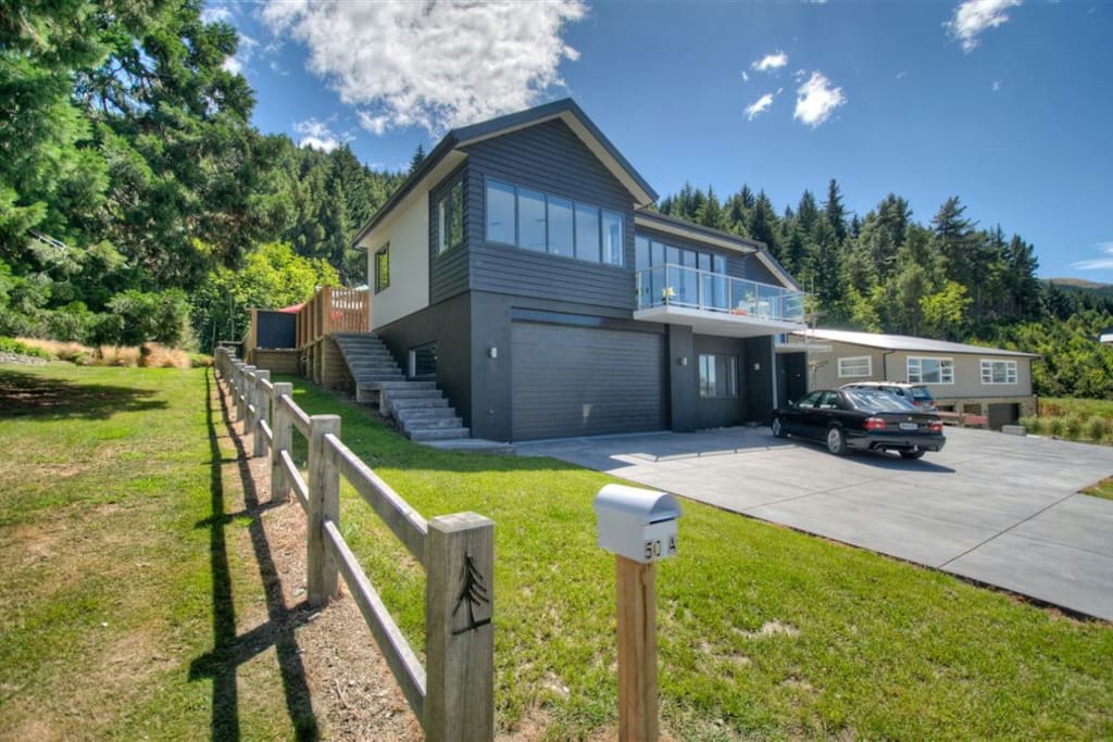 The house from the front. Your room's door is to the right of the garage (Summer View)