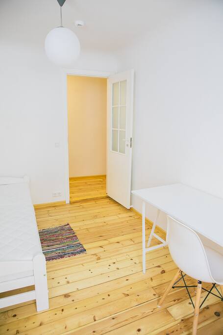 Room 2. Single bed, wardrobe, large table for work