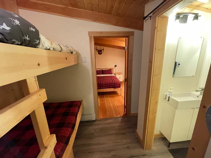 Bunkhouse showing bunk beds, half bath and bedroom with Queen bed.