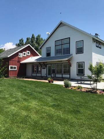 Custom Farm House surrounded by open fields.