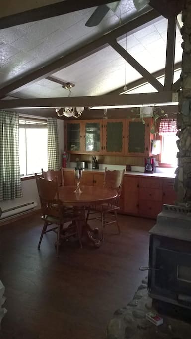 Dining room table has a leaf and extends to seat 6, chairs included.
