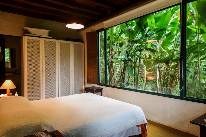 Bedroom 1 (master suite with glass wall overlooking the forest)