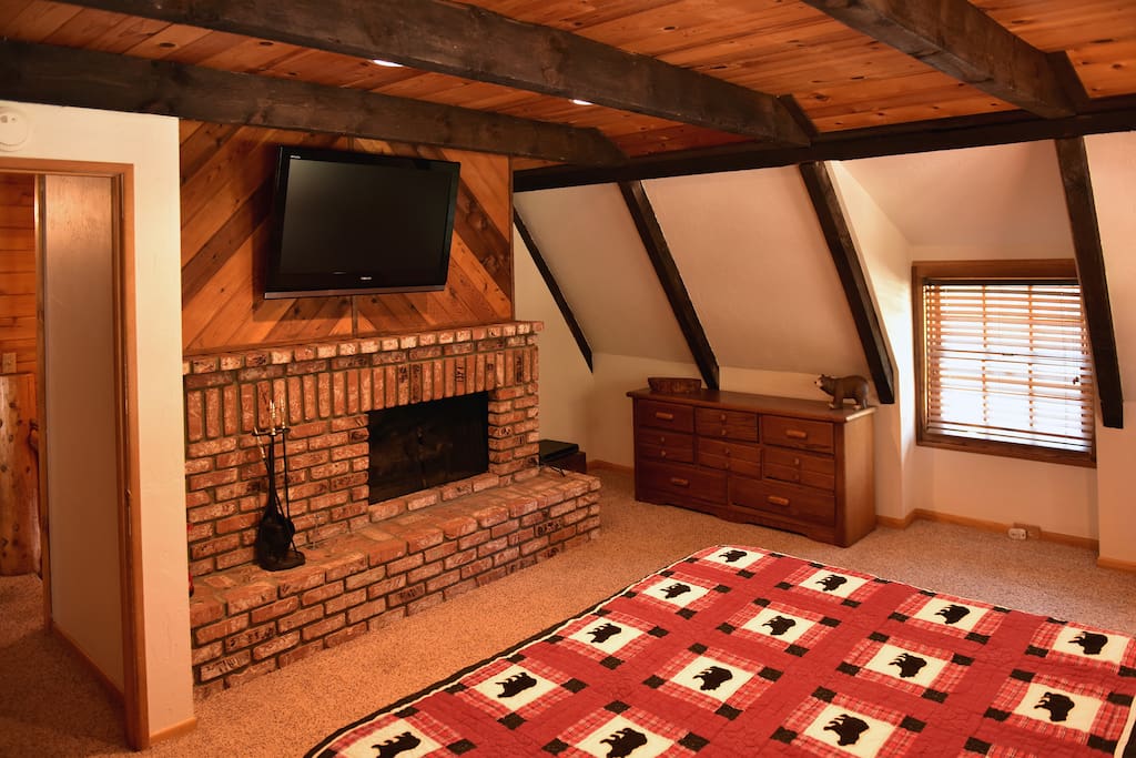 Master bedroom with fireplace, flatscreen TV and a King bed.
