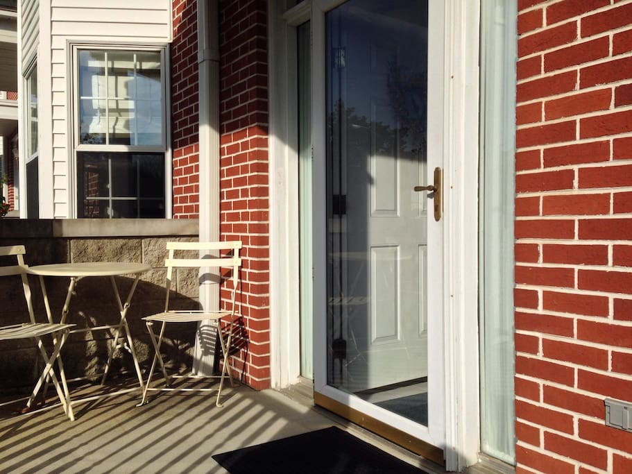 Table and chairs on front porch to watch the world go by on 7th street.