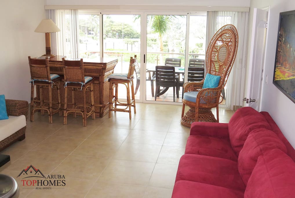 Living Room area leading to one of the balconies with pool and beach view.