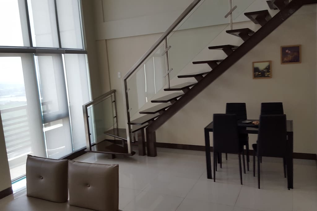 Dining Area and Staircase to Upper Level Bedroom, Shower and Toilet