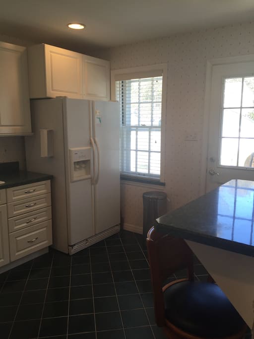 Kitchen with frig, dishwasher, and microwave