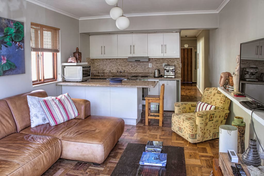 Lounge area with open plan kitchen in the background