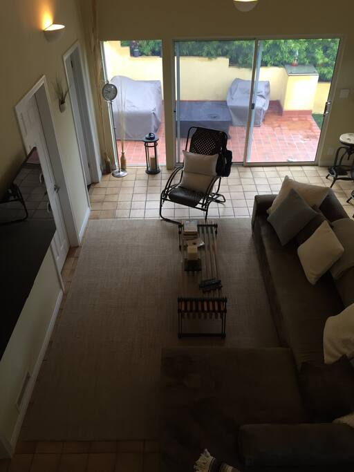 Family Room with 60" 4K TV. Vaulted 24' ceiling, patio with fire pit and ocean view