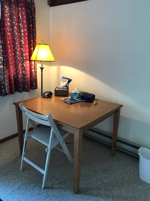 Table and chair to use as desk or if you would like to eat in private you can or have a space at our shared dining room