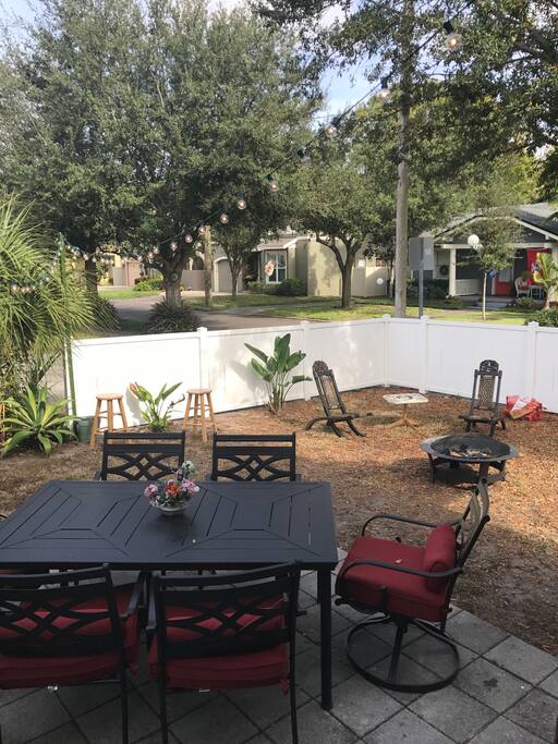 Private backyard with bistro lights and fire pit
