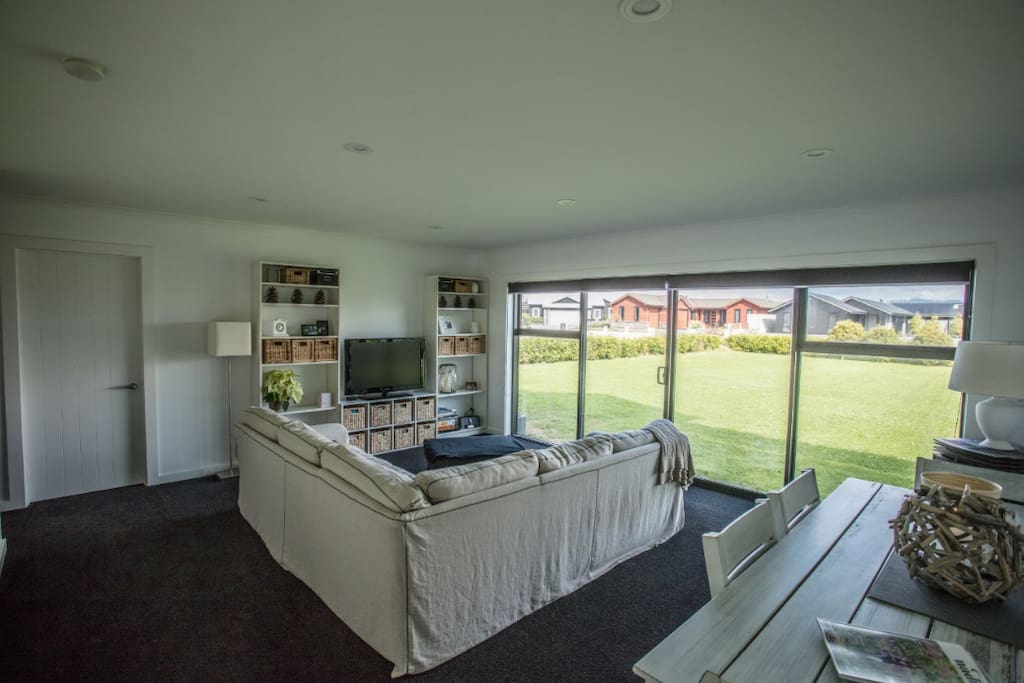 The living/dining area which leads out onto the front lawn now with large patio area. Sky TV and DVD player.