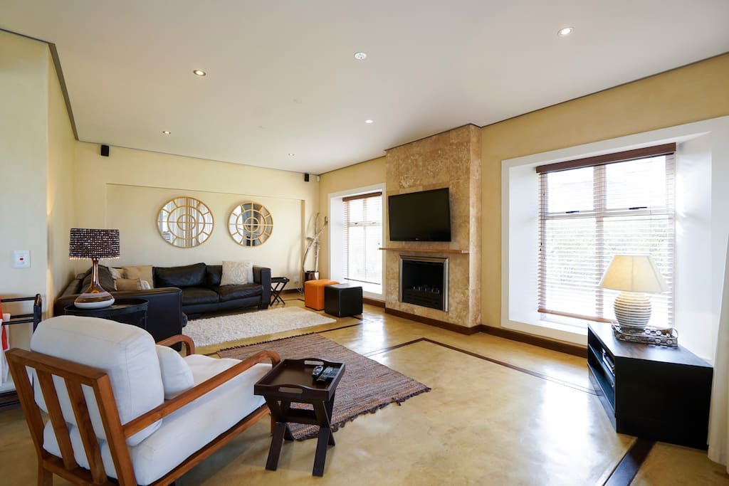 wide angle shot of lounge area with Plasma TV and full bouquet DSTV