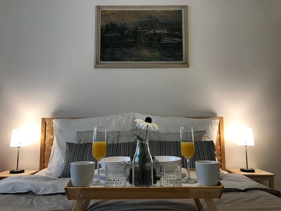 Cozy bed with a breakfast set