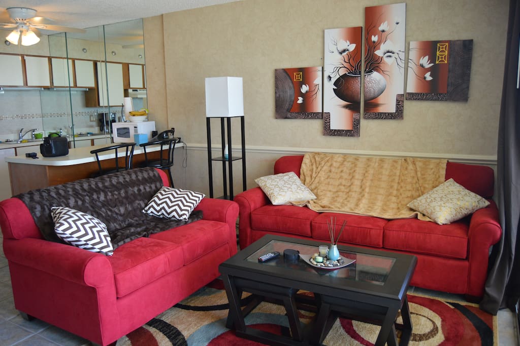 Living room. The couch, up against the wall, has a pull out bed!