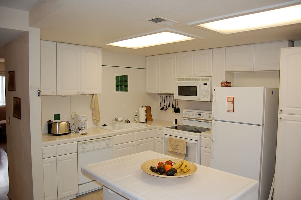 Stocked kitchen with french doors to patio