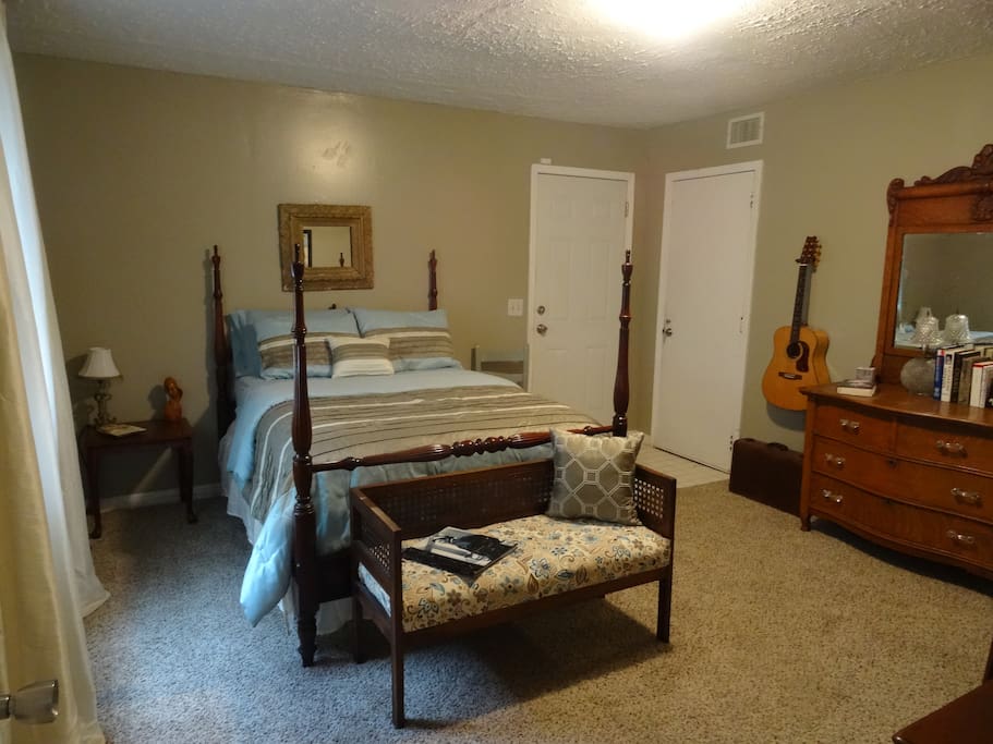 This view includes the antique dresser with plenty of drawer space and a guitar to enjoy for those who play.