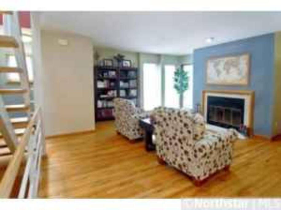 Open floor plan with fireplace and lots of natural light