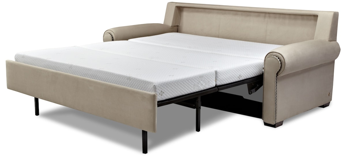 A comfortable pull-out sofa bed is displayed, featuring smooth, neutral-colored upholstery. The mattress is shown fully extended, providing additional sleeping space. The sofa's sleek design includes rounded armrests, contributing to a modern aesthetic suitable for cozy accommodations.