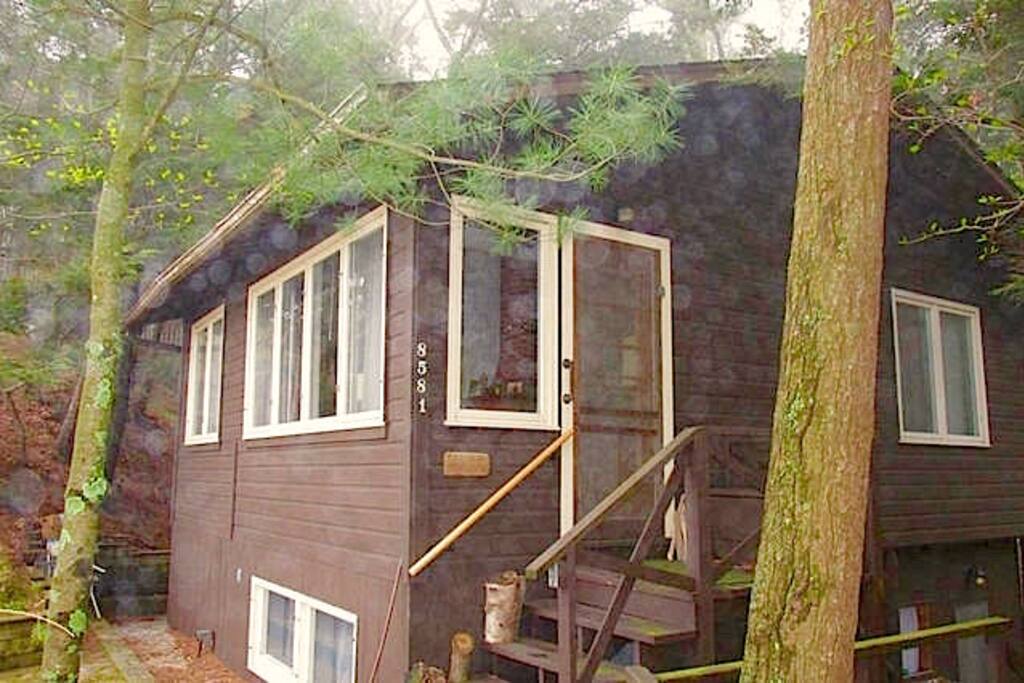 Front of cottage with views of Lake Michigan. Not shown in picture is the stone porch directly in front of cottage with barbeque and sitting areas - also with views of Lake Michigan.