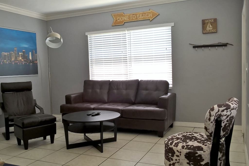 Spacious living room. Queen sized sofa bed, comfortable chairs, and ottoman.