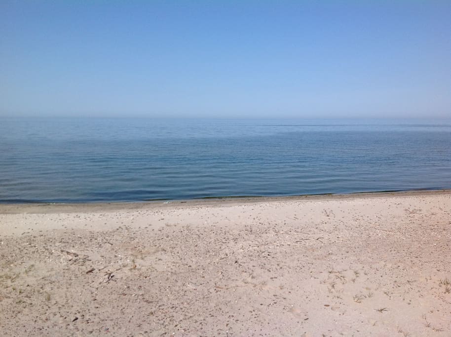 Gorgeous Lake Ontario. This large modern beach house is on sandy beach on a cove with only a few houses. the rest of the lake front for miles in either direction are all breakwalls or rocks. This little cove is so unique to have only soft sandy beach front.