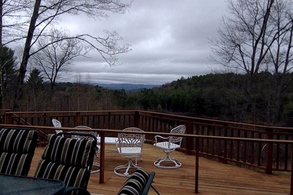 Mountain views over large pond off large deck.