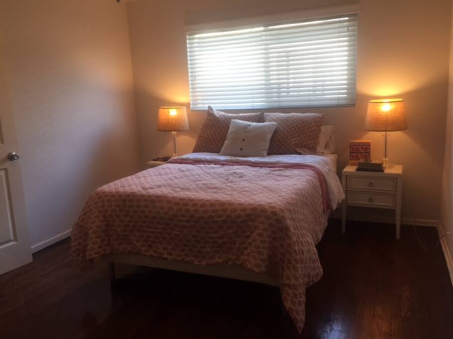 Large bedroom with hard wood floors and a big closet.