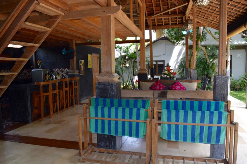 The open-air Javanese timber building, called a joglo, serves as our outdoor living space. Complete with dining, lounge, kitchen/bar and a third bathroom. Upstairs is a massage area with 2 massage tables where on-call therapists can do their magic .