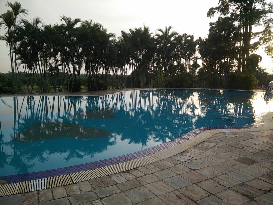 large swimming pool in front of the hotel with a great view of the golf coarse