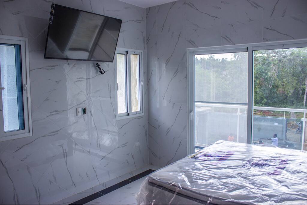 Wall To Wall Tile In Each Bedroom With Balcony And 49 Inch Big Screen Tv