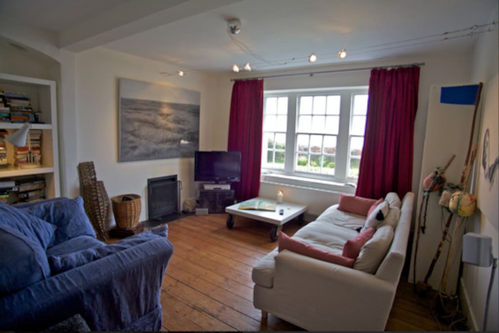 Cozy living room with sea view and open fire