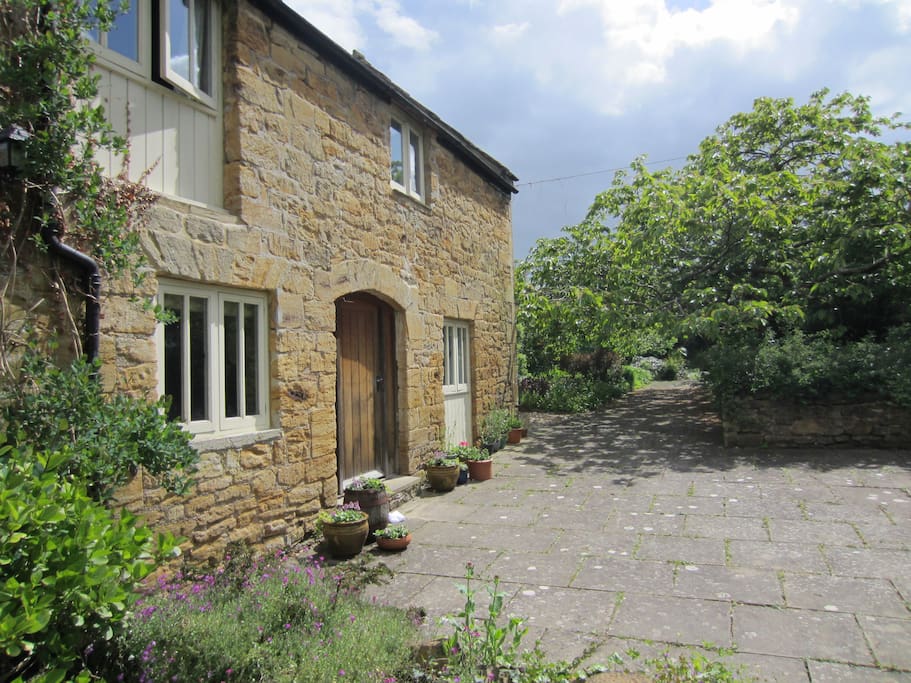 The cottage sits in a quiet garden away from the road