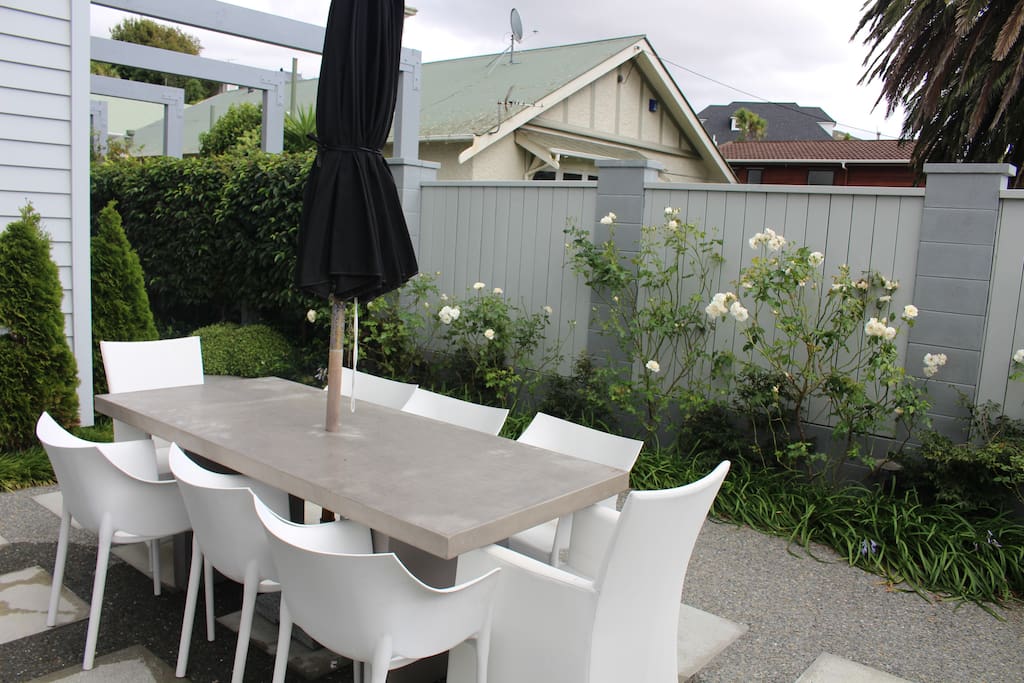 Umbrella-covered outdoor dining, seats 8