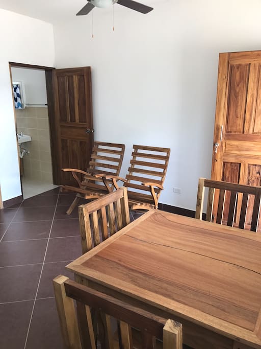 Wooden dining table with seating for four. Two extra chairs for relaxing as well.