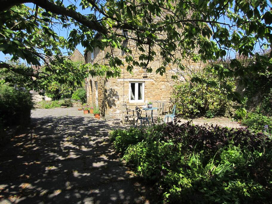 The cottage sits in a quiet garden away from the road