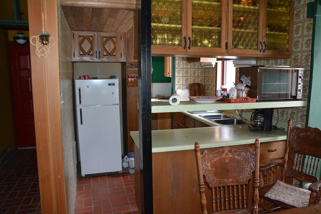 Looking from the dining area to the kitchen and pantry