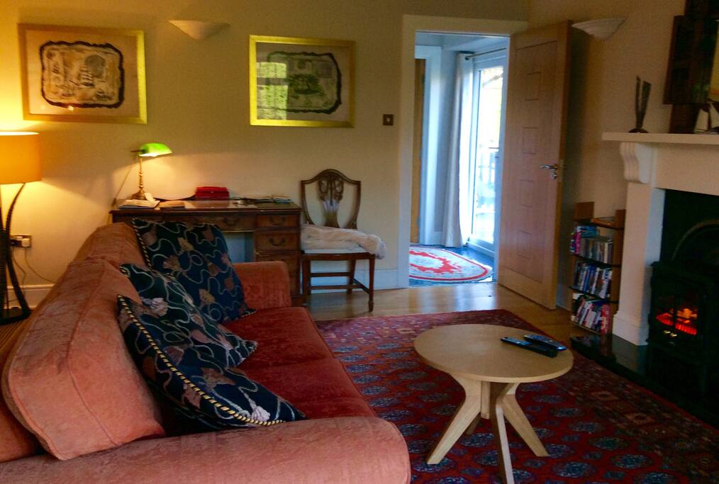 Living/sitting room with comfortable couch and desk for guests only